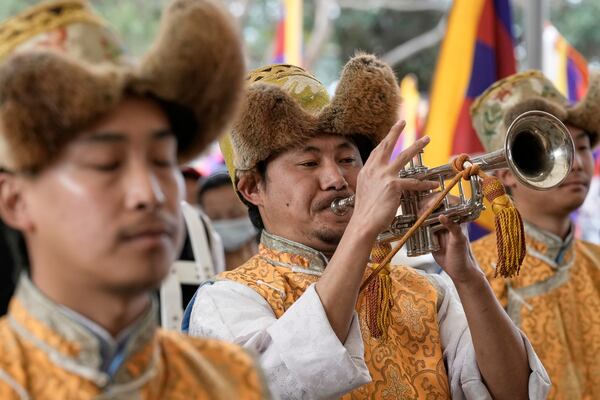 Exiled Tibetan artists play a tune to mark the 66th anniversary of an uprising in Tibetan capital Lhasa, as they gather at the Tsuglakhang temple in Dharamshala, India, Monday, March 10, 2025. (AP Photo/Ashwini Bhatia)