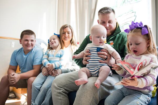 In this photo provided by the Children's Hospital of Philadelphia, KJ Muldoon sits with his parents, Kyle and Nicole Muldoon, and his siblings after a follow up dose of an experimental gene editing treatment at the hospital in April 2025. (Chloe Dawson/Children's Hospital of Philadelphia via AP)