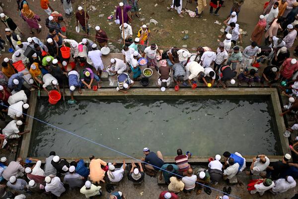 Muslim devotees perform ablutions before prayers during the first phase of the three-day Biswa Ijtema, or the World Congregation of Muslims, at the banks of the Turag river in Tongi, near Dhaka, Bangladesh, Friday, Jan. 31, 2025. (AP Photo/Mahmud Hossain Opu)