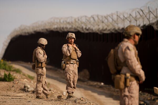 U.S. Marines install barbed wire along the border fence Friday, Jan. 31, 2025, in San Diego. (AP Photo/Jae C. Hong)