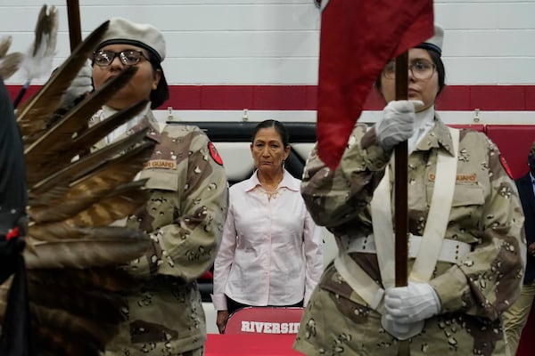 FILE - U.S. Secretary of the Interior Deb Haaland stands as the Riverside Indian School color guard presents the colors Saturday, July 9, 2022, in Anadarko, Okla. (AP Photo/Sue Ogrocki, File)