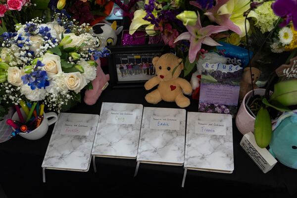 A memorial is seen along the boards at MedStar Capitals Iceplex Sunday, Feb. 2, 2025, in Arlington, Va., for the figure skaters who were among the 67 victims of a mid-air collision between an Army helicopter and an American Airlines flight from Kansas. (AP Photo/Carolyn Kaster)