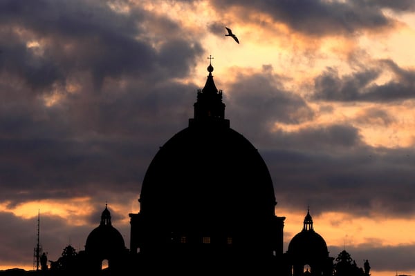 Dark clouds hover over St Peter's Basilica at the Vatican in Rome, Sunday, March 2, 2025. (AP Photo/Kirsty Wigglesworth)