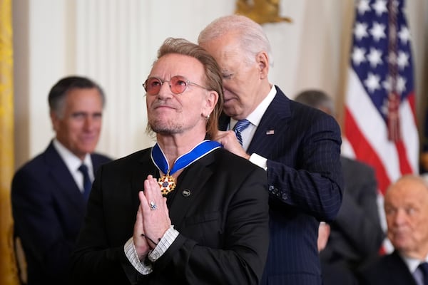 Bono gestures as President Joe Biden presents him with the Presidential Medal of Freedom, the Nation's highest civilian honor, in the East Room of the White House, Saturday, Jan. 4, 2025, in Washington. (AP Photo/Manuel Balce Ceneta)