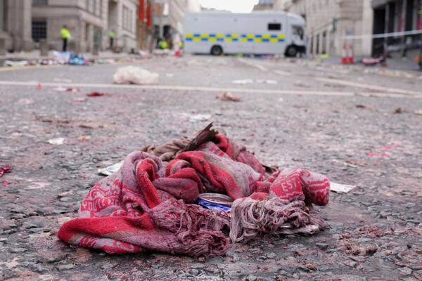 A fan scarf lies near the site where a 53-year-old British man plowed a minivan into a crowd of Liverpool soccer fans who were celebrating the city's Premier League championship Monday, injuring more than 45 people in Liverpool, England, Tuesday, May 27, 2025.(AP Photo/Jon Super)