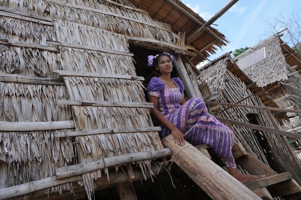 Loba Klathale sits on her house in Moken village at Surin Islands in Phang Nga Province, Thailand, Wednesday, Dec. 11, 2024. (AP Photo/Sakchai Lalit)