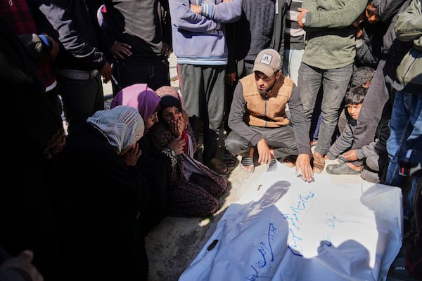 Mourners gather around the bodies of Palestinians killed in the Israeli bombardment of the Gaza Strip as they are brought for burial at Nasser Hospital in Khan Younis, Sunday, March 23, 2025. (AP Photo/Abdel Kareem Hana)