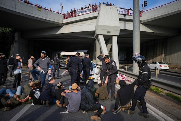 Police disperse demonstrators who are blocking a road during a protest against the ceasefire deal between Israel and Hamas in Jerusalem on Thursday, Jan. 16, 2025. (AP Photo/Ohad Zwigenberg)