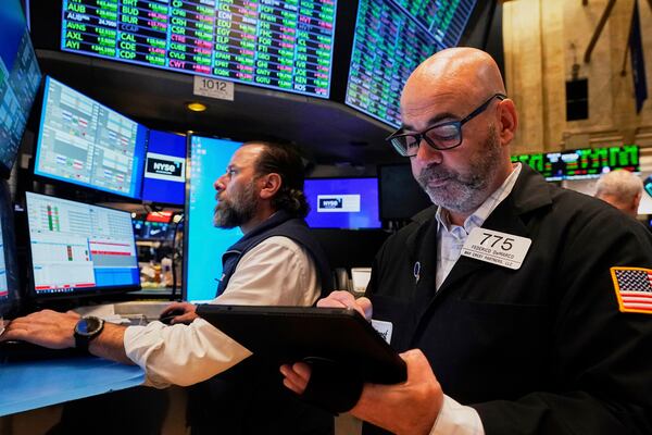 Specialist Michael Pistillo, left, and trader Fred Demarco work on the floor of the New York Stock Exchange, Friday, May 2, 2025. (AP Photo/Richard Drew)