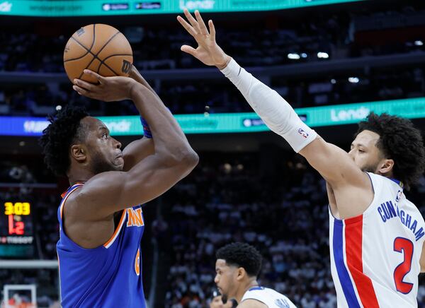 New York Knicks forward OG Anunoby, left, looks to shoot against Detroit Pistons guard Cade Cunningham (2) during the first half of Game 6 of an NBA basketball first-round playoff series Thursday, May 1, 2025, in Detroit. (AP Photo/Duane Burleson)