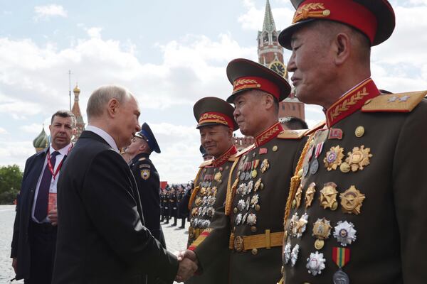 Russian President Vladimir Putin, left, speaks with North Korean officers after the Victory Day military parade in Moscow, Russia, Friday, May 9, 2025, during celebrations of the 80th anniversary of the Soviet Union's victory over Nazi Germany during the World War II. (Gavriil Grigorov, Sputnik, Kremlin Pool Photo via AP)