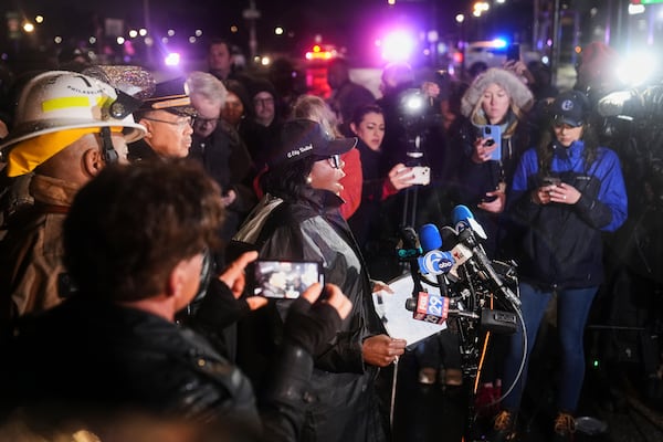 Philadelphia Mayor Cherelle Parker, center, speaks during a news conference in Philadelphia, Friday, Jan. 31, 2025. (AP Photo/Matt Rourke)