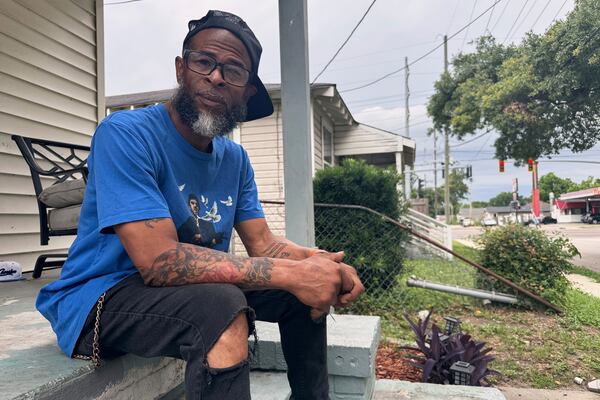 Mario Westbrook sits on his porch, May 21, 2025, in New Orleans East, where he says the community has long had negative experiences with law enforcement. (AP Photo/Jack Brook)