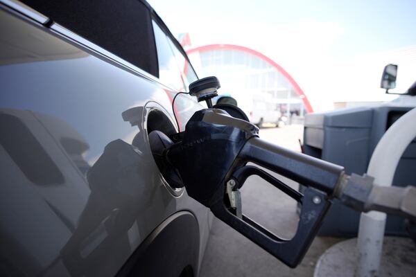 FILE - A motorist fills up their car at a Shell gas station ahead of Memorial Day, Friday, May 26, 2023, in Commerce City, Colo. (AP Photo/David Zalubowski, File)