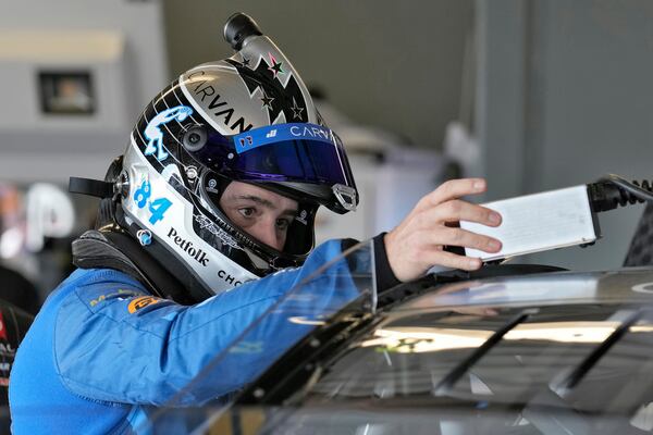 Jimmie Johnson checks his equipment before a practice for the NASCAR Daytona 500 auto race Wednesday, Feb. 12, 2025, at Daytona International Speedway in Daytona Beach, Fla. (AP Photo/Chris O'Meara)