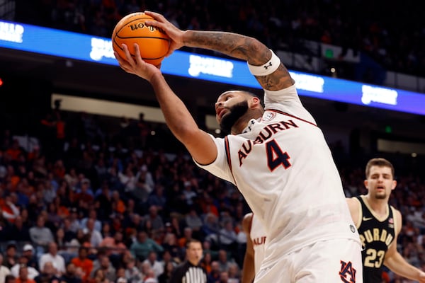 Auburn forward Johni Broome rebounds a ball against Purdue during the second half of an NCAA college basketball game, Saturday, Dec. 21, 2024, in Birmingham, Ala. (AP Photo/ Butch Dill)