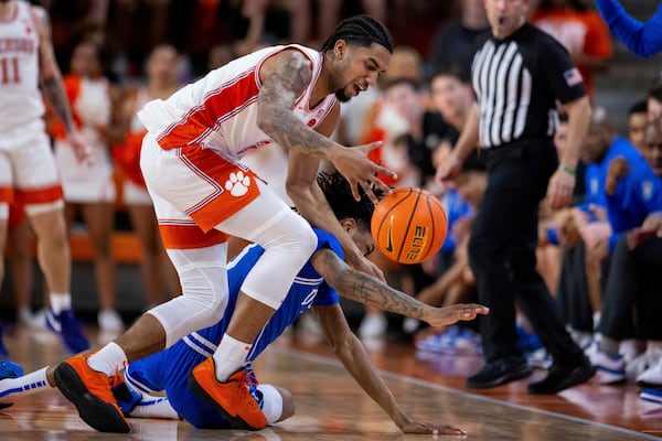 Clemson guard Dillon Hunter and Duke guard Isaiah Evans chase a loose ball during the first half of an NCAA college basketball game on Saturday, Feb. 8, 2025, in Clemson, S.C. (AP Photo/Scott Kinser)