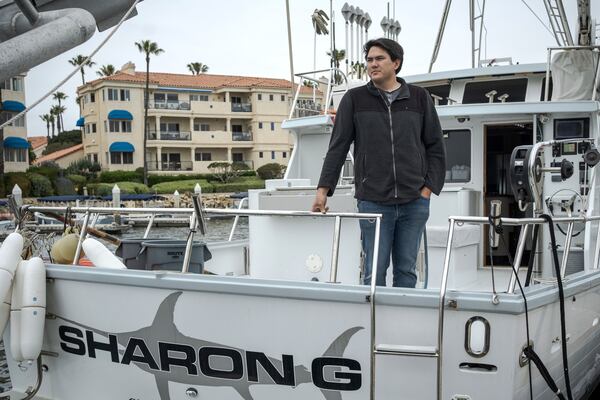 Blake Hermann, a fourth-generation commercial fisherman, poses for a portrait aboard his boat in Oxnard, Calif., Thursday, May 1, 2025. (AP Photo/Annika Hammerschlag)