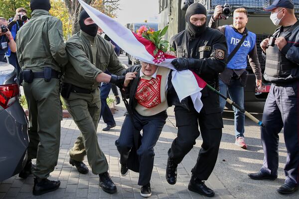 FILE - Police officers detain Nina Bahinskaya, 73, during an opposition rally to protest the official presidential election results in Minsk, Belarus, Saturday, Sept. 19, 2020. (AP Photo/TUT.by, File)