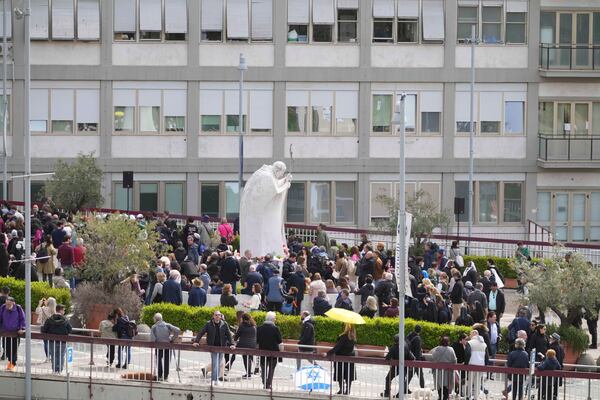 People wait before Pope Francis will appear at a window of the Agostino Gemelli Polyclinic in Rome, Sunday, March 23, 2025, where he has been treated for bronchitis and bilateral pneumonia since Feb. 14. (AP Photo/Andrew Medichini)