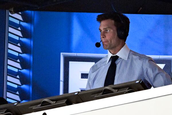 FILE 0- Former NFL quarterback Tom Brady looks on from the broadcast booth during the second half of an NFL football game between the Dallas Cowboys and the New Orleans Saints, Sunday, Sept. 15, 2024, in Arlington, Texas. (AP Photo/Jerome Miron, File)