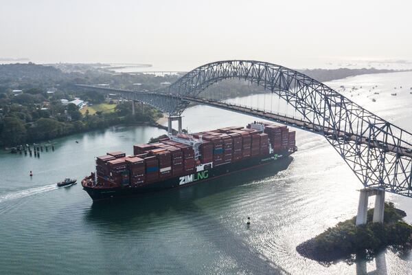 A cargo ship sails under Las Americas bridge through the Panama Canal, in Panama City, Saturday, Feb. 1, 2025. (AP Photo/Matias Delacroix)