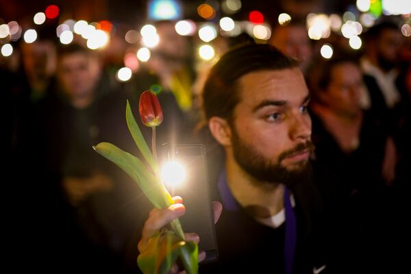 People hold up their mobile phone lights during a protest over the collapse of a concrete canopy that killed 15 people more than two months ago, in Novi Sad, Serbia, Friday, Jan. 31, 2025. (AP Photo/Armin Durgut)