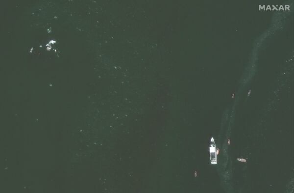 This satellite image provided by Maxar Technologies shows recovery efforts around the wreckage site in the Potomac River from Ronald Reagan Washington National Airport, Thursday, Jan. 30, 2025, near Arlington, Va. (Maxar Technologies via AP)