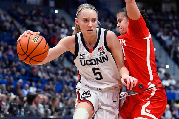 FILE - UConn guard Paige Bueckers (5) is guarded by Boston University guard Alex Giannaros in the first half of an NCAA college basketball game, Thursday, Nov. 7, 2024, in Hartford, Conn. (AP Photo/Jessica Hill, File)