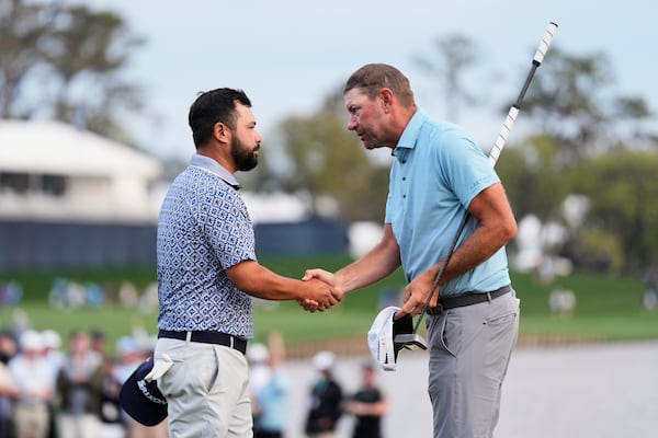 J.J. Spaun, left, greets Lucas Glover after the finish the 18th hole during the final round of The Players Championship golf tournament Sunday, March 16, 2025, in Ponte Vedra Beach, Fla. (AP Photo/Julia Demaree Nikhinson)