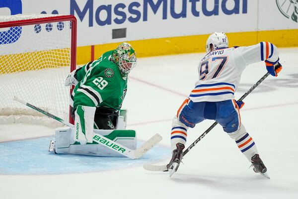 FILE - Edmonton Oilers center Connor McDavid (97) prepares to shoot against Dallas Stars goaltender Jake Oettinger (29) during overtime in Game 1 of the NHL hockey Western Conference Stanley Cup playoff finals, May 23, 2024, in Dallas. (AP Photo/Tony Gutierrez, File)