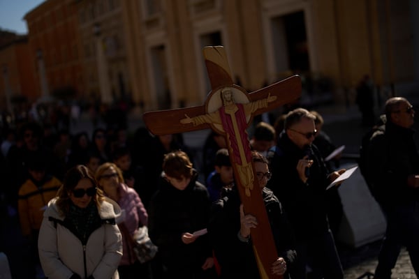 Christian Catholic worshippers pray as they walk towards St. Peter's Square, in Rome, Italy, Thursday, March 6, 2025. (AP Photo/Francisco Seco)