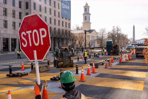 With the White House in the background, demolition begins on the Black Lives Matter mural, Monday, March 10, 2025, in Washington. (AP Photo/Jacquelyn Martin)