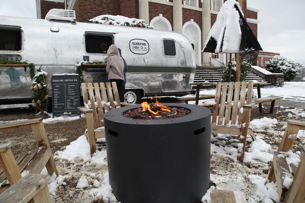 People order food outside Bad Luck Burger Club after snow fell in the area in Nashville, Tenn. on Saturday, Jan.11, 2025. (AP Photo/Kristin M. Hall)