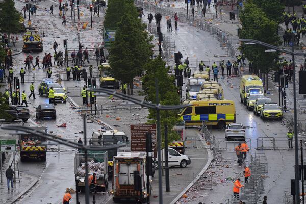 Police and emergency personnel deal with an incident on Water Street near the Liver Building in Liverpool after a car collided with pedestrians during the Premier League winners parade, in Liverpool, England, Monday May 26, 2025. (Danny Lawson/PA via AP)