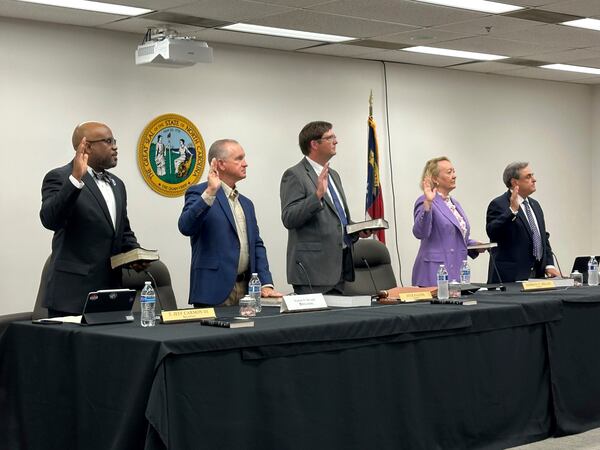 Newly appointed members of the North Carolina State Board of Elections, from left, Jeff Carmon, Francis De Luca, Stacy "Four" Eggers, Siobhan O'Duffy Millen and Bob Rucho, take their oaths of office at the Dobbs Building in Raleigh, N.C., on Wednesday, May 7, 2025 (AP Photo/Gary D. Robertson)