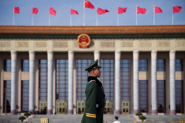 A Chinese paramilitary policeman stands guard during a preparatory session meeting of China's National People's Congress (NPC) at the Great Hall of the People in Beijing, China, Tuesday, March 4, 2025. (AP Photo/Vincent Thian)