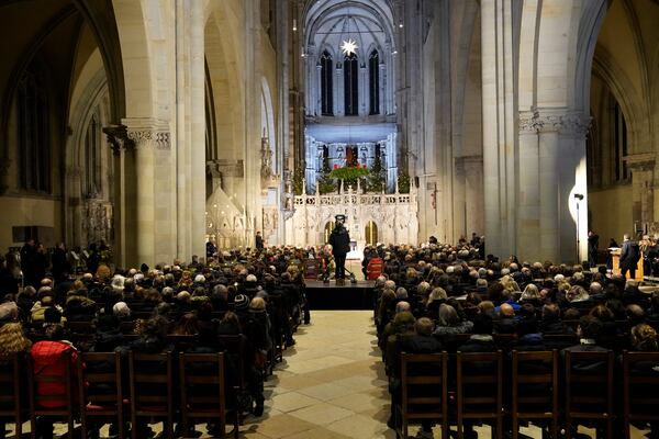 People attend a memorial service for victims of Friday's Christmas Market attack, where a car drove into a crowd, in Magdeburg, Germany, Saturday, Dec. 21, 2024. (AP Photo/Ebrahim Noroozi)