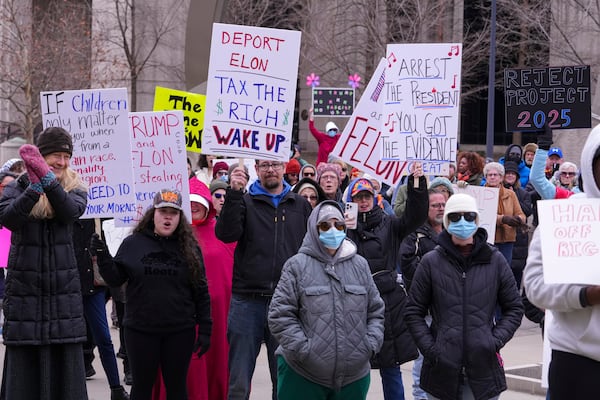 Protestors gather for a rally against Project 2025 at the Statehouse in Indianapolis, Wednesday, Feb. 5, 2025. (AP Photo/Michael Conroy)