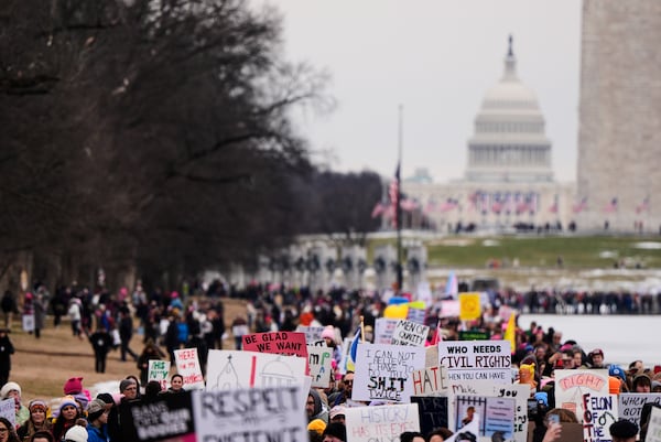 EDS NOTE: OBSCENITY - People march in the People's March, Saturday, Jan. 18, 2025, in Washington. (AP Photo/Mike Stewart)