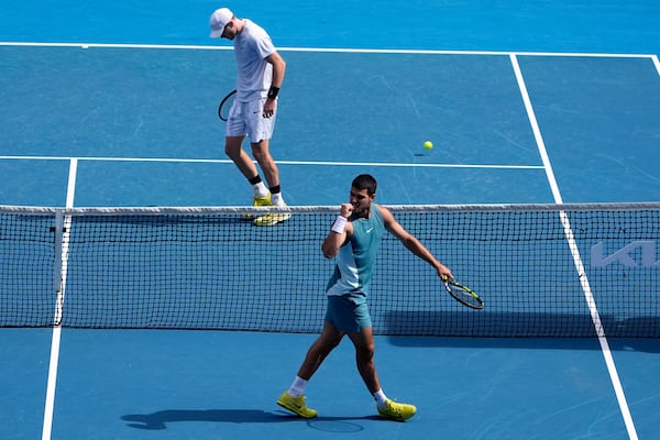 Carlos Alcaraz of Spain reacts during a fourth round match against Jack Draper of Britain, left, at the Australian Open tennis championship in Melbourne, Australia, Sunday, Jan. 19, 2025. (AP Photo/Asanka Brendon Ratnayake)