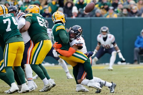 Chicago Bears safety Kevin Byard III (31) forces Green Bay Packers quarterback Malik Willis to fumble the ball, which was recovered by the Bears, during the second half of an NFL football game, Sunday, Jan. 5, 2025, in Green Bay, Wis. (AP Photo/Mike Roemer)