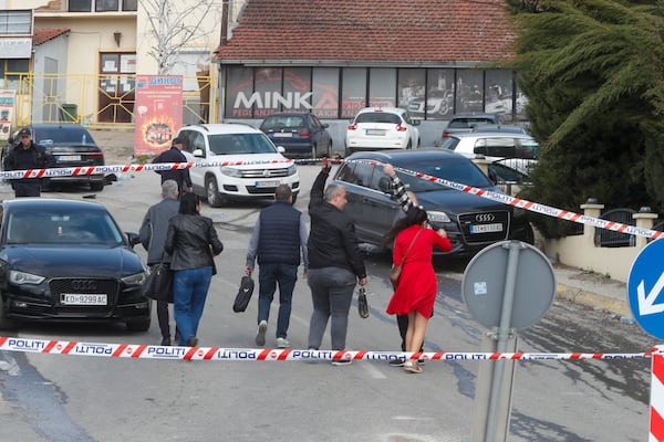 Prosecutors arrive at the scene of a massive fire in a nightclub in the town of Kocani, North Macedonia, Sunday, March 16, 2025. (AP Photo/Boris Grdanoski)