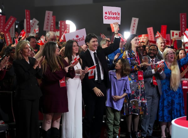 Prime Minister Justin Trudeau cheers as Liberal Party of Canada Leader Mark Carney delivers his victory speech during the the Liberal leadership announcement event in Ottawa, Ontario, Sunday, March 9, 2025. (Sean Kilpatrick/The Canadian Press via AP)