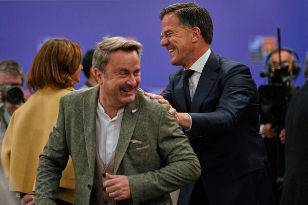 NATO Secretary-General Mark Rutte, right, talks to Luxembourg's Foreign Minister Xavier Bettel as they arrive for a group photo during a NATO's informal meeting of foreign ministers in Antalya, southern Turkey, Thursday, May 15, 2025. (AP Photo/Khalil Hamra)