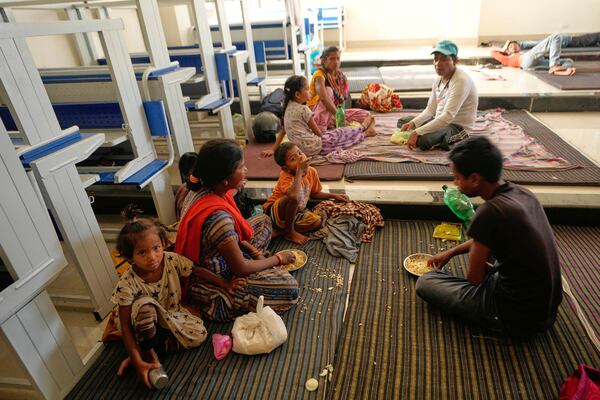 Villagers living along the border between India and Pakistan have food at a college where they have taken shelter following artillery shelling from Pakistan, on the outskirts of Jammu, India, Friday, May 9, 2025.(AP Photo/Channi Anand)