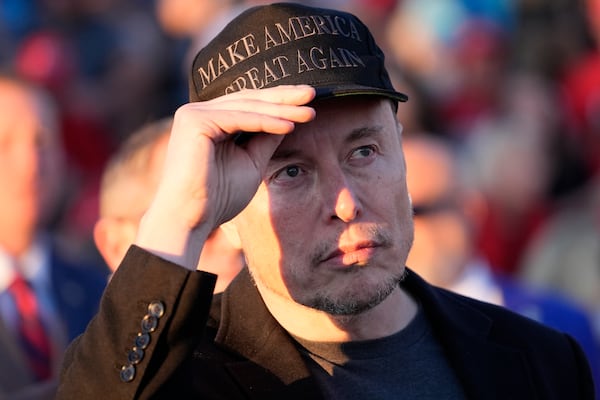 FILE - Tesla and SpaceX CEO Elon Musk listens as Republican presidential nominee former President Donald Trump speaks at a campaign event at the Butler Farm Show, on Oct. 5, 2024, in Butler, Pa. (AP Photo/Alex Brandon, File)