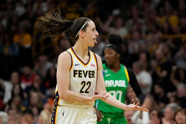 Indiana Fever guard Caitlin Clark (22) reacts after making a 3-point basket during the first half of an exhibition women's basketball game against Brazil, Sunday, May 4, 2025, in Iowa City, Iowa. (AP Photo/Charlie Neibergall)