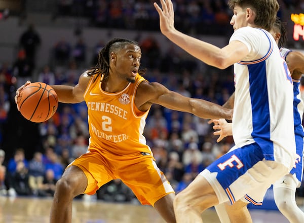 Tennessee guard Chaz Lanier (2) drives on Florida forward Alex Condon, right, during the first half of an NCAA college basketball game Tuesday, Jan. 7, 2025, in Gainesville, Fla. (AP Photo/Alan Youngblood)