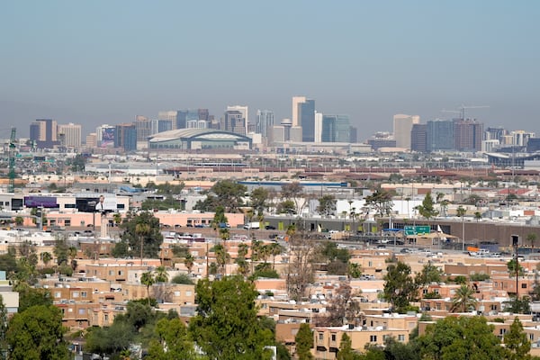 FILE - Condos and apartments give way to the Phoenix skyline Tuesday, Sept. 24, 2024, in Tempe, Ariz. (AP Photo/Ross D. Franklin)